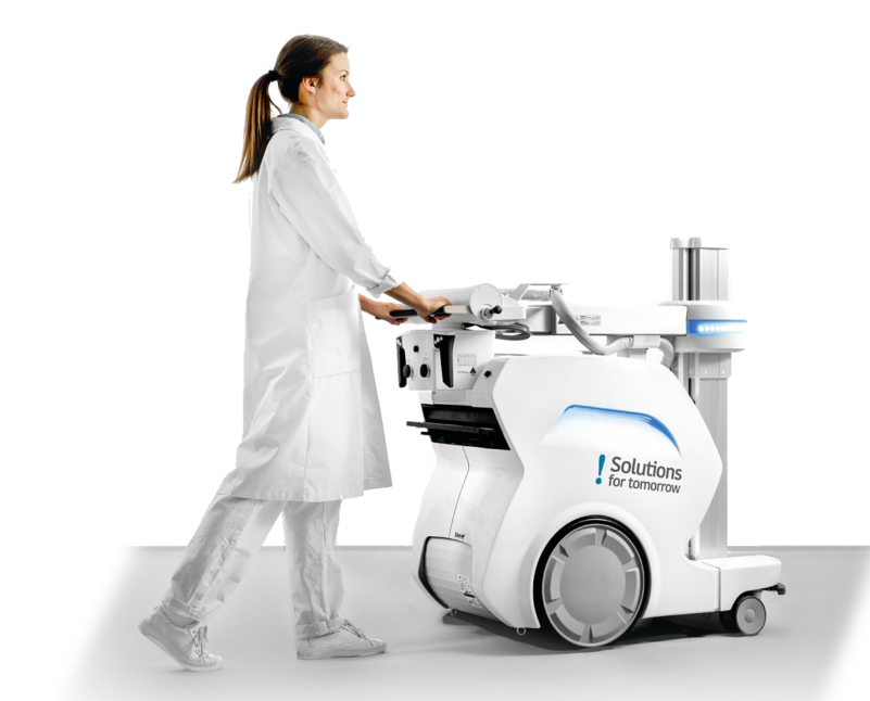 a nurse is moving an x-ray machine